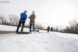 The group Stop Oversalting demonstrates clearing snow instead of salting.