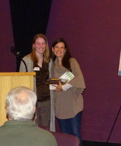 Charlotte, Volunteer of the Year, poses with a staff member