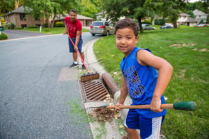 People cleaning up a stormdrain