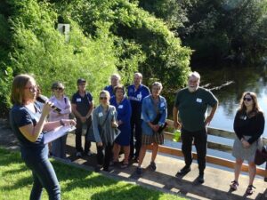 An educator teaching a class by a river