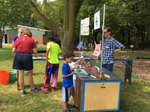 Kids paint rubber fish at the popup cart