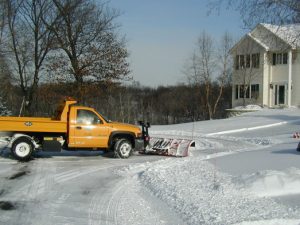Residential snow plow removing snow