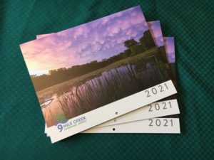 stack of calendars on table cloth