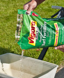 Image of fertilizer being poured into a spreader